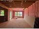 Open-plan living room construction with pink insulation, large windows, and exposed wooden beams at 2753 S Waterworks Rd, Buford, GA 30518