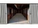 Barn with a long hallway of horse stalls and a concrete floor at 3011 Flat Shoals Sw Rd, Conyers, GA 30094