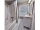 Well-lit bathroom featuring tiled floors, new sink vanity, and bathtub shower at 3011 Flat Shoals Sw Rd, Conyers, GA 30094