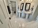 Elegant bathroom featuring double sinks, sleek fixtures, neutral decor, and a glimpse of a shower/bath area at 3011 Flat Shoals Sw Rd, Conyers, GA 30094