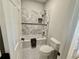 Bathroom features tile surround, matching toilet, and dark fixtures for a modern feel at 3011 Flat Shoals Sw Rd, Conyers, GA 30094