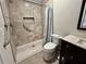 Walk-in shower with grab bars, a built-in toiletry niche, and decorative stone details at 3011 Flat Shoals Sw Rd, Conyers, GA 30094