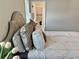 Cozy bedroom leads to ensuite bath; neutral bedding and flowers for a tranquil, comfortable, appealing retreat at 3011 Flat Shoals Sw Rd, Conyers, GA 30094
