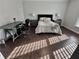 Comfortable bedroom boasts hardwood floors, neutral walls, and stylish décor with ample natural light at 3011 Flat Shoals Sw Rd, Conyers, GA 30094
