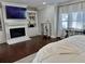 Bedroom with a white fireplace, built-in shelving, dark wood floors, and large windows at 3011 Flat Shoals Sw Rd, Conyers, GA 30094