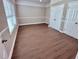 Bright bedroom showcasing new wood flooring, fresh paint, and ample closet space at 3011 Flat Shoals Sw Rd, Conyers, GA 30094