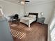 Comfortable bedroom featuring hardwood floors, neutral walls, and stylish décor with lots of natural light at 3011 Flat Shoals Sw Rd, Conyers, GA 30094