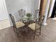 Dining area boasting a glass table, seating for four, and wood-look flooring at 3011 Flat Shoals Sw Rd, Conyers, GA 30094