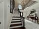 Foyer featuring elegant staircase, a crystal chandelier, wood railing, and marble floors at 3011 Flat Shoals Sw Rd, Conyers, GA 30094