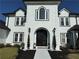 Close-up of the ornate black front door with decorative lights and a paved walkway at 3011 Flat Shoals Sw Rd, Conyers, GA 30094