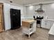 Updated kitchen featuring a stainless steel stove, white cabinets, and a butcher block island at 3011 Flat Shoals Sw Rd, Conyers, GA 30094