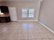 Spacious living area with tile flooring, neutral paint, and natural light from a large window at 3011 Flat Shoals Sw Rd, Conyers, GA 30094