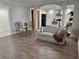 Inviting living room featuring wood-look tile floors and an open concept kitchen at 3011 Flat Shoals Sw Rd, Conyers, GA 30094