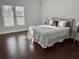 Bright main bedroom featuring hardwood floors, a queen-sized bed, and bright windows at 3011 Flat Shoals Sw Rd, Conyers, GA 30094