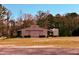 Spacious metal outbuilding with large barn doors and a trailer nearby, perfect for storage at 3011 Flat Shoals Sw Rd, Conyers, GA 30094