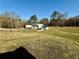 Wide shot of two garages, one with an awning, located on an expansive grassy lot at 3011 Flat Shoals Sw Rd, Conyers, GA 30094