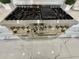 Close up of stainless steel range with gold knobs and handles against a marble floor at 3011 Flat Shoals Sw Rd, Conyers, GA 30094