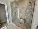 Glass enclosed shower with tiled walls, built-in niche, and shower bench at 3011 Flat Shoals Sw Rd, Conyers, GA 30094