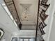 Elegant staircase with a decorative chandelier and wrought iron railings at 3011 Flat Shoals Sw Rd, Conyers, GA 30094