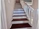 Elegant staircase featuring wood steps, a white railing, and fresh paint at 3011 Flat Shoals Sw Rd, Conyers, GA 30094