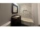 Bathroom featuring a marble tile shower and dark wood vanity at 6538 N Sweetwater Rd, Lithia Springs, GA 30122