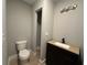 Half bathroom featuring stylish vanity with granite countertop and updated fixtures, perfect for guests at 6538 N Sweetwater Rd, Lithia Springs, GA 30122