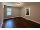 Well-lit bedroom with hardwood floors and light gray walls offers a calming retreat with natural light at 6538 N Sweetwater Rd, Lithia Springs, GA 30122