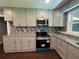 Modern kitchen with updated cabinets, sleek countertops, and stainless steel appliances, perfect for cooking at 6538 N Sweetwater Rd, Lithia Springs, GA 30122