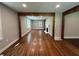 Spacious living room with hardwood floors and brick fireplace feature, providing an open and airy feel at 6538 N Sweetwater Rd, Lithia Springs, GA 30122