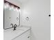 Bathroom featuring white vanity with granite countertops, modern fixtures and a decorative mirror at 1601 Augusta Se Dr, Marietta, GA 30067