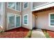 Exterior of condo building featuring beige siding, white door and decorative landscaping at 1601 Augusta Se Dr, Marietta, GA 30067