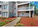 Multi-story exterior of condo featuring beige siding, multiple windows and outdoor balcony at 1601 Augusta Se Dr, Marietta, GA 30067