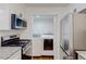 Well-equipped kitchen with stainless steel appliances and adjacent laundry area at 1601 Augusta Se Dr, Marietta, GA 30067