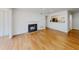 Bright living room featuring a classic fireplace, hardwood floors and an open view of the modern kitchen at 1601 Augusta Se Dr, Marietta, GA 30067