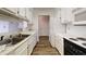 Galley style kitchen with white cabinetry and appliances at 300 Johnson Ferry Ne Rd # B604, Atlanta, GA 30328