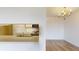 Open concept kitchen with a view of the chandelier lit dining space at 300 Johnson Ferry Ne Rd # B604, Atlanta, GA 30328