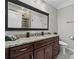 Elegant bathroom with granite countertop, dark wood cabinetry, and modern fixtures at 325 E Paces Ferry Ne Rd # 703, Atlanta, GA 30305