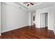 Spacious bedroom featuring hardwood floors, a tray ceiling, and multiple doorways at 325 E Paces Ferry Ne Rd # 703, Atlanta, GA 30305