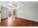Bedroom featuring hardwood floors, a sliding glass door to balcony, and plenty of natural light at 325 E Paces Ferry Ne Rd # 703, Atlanta, GA 30305