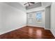 Bedroom with neutral walls, hardwood floors, tray ceiling, and natural light from two windows at 325 E Paces Ferry Ne Rd # 703, Atlanta, GA 30305