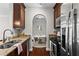 Well-equipped kitchen with granite countertops, stainless steel appliances, and dark wood cabinets at 325 E Paces Ferry Ne Rd # 703, Atlanta, GA 30305