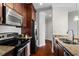 A well-appointed kitchen boasts stainless steel appliances and sleek dark cabinets at 325 E Paces Ferry Ne Rd # 703, Atlanta, GA 30305