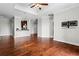 Spacious living room showcasing hardwood floors, neutral walls, and a kitchen counter with barstools at 325 E Paces Ferry Ne Rd # 703, Atlanta, GA 30305