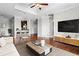 Bright and airy living room with wood floors, a coffered ceiling, and a modern entertainment center at 325 E Paces Ferry Ne Rd # 703, Atlanta, GA 30305