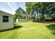 The backyard features a large grassy lawn and a detached four car garage at 4150 Glenn St, Powder Springs, GA 30127