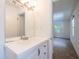 Bright bathroom vanity with a large mirror and views into the bedroom at 4150 Glenn St, Powder Springs, GA 30127