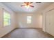 Cozy bedroom with two windows, neutral carpet, and a convenient closet at 4150 Glenn St, Powder Springs, GA 30127