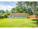 A detached four car garage with ample space for vehicles and storage in a spacious green backyard at 4150 Glenn St, Powder Springs, GA 30127