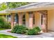 Inviting front porch with brick arches and manicured landscaping, adding curb appeal to this home at 4150 Glenn St, Powder Springs, GA 30127