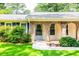 Attractive front porch with brick detailing and lush greenery, enhancing the home's welcoming entrance at 4150 Glenn St, Powder Springs, GA 30127